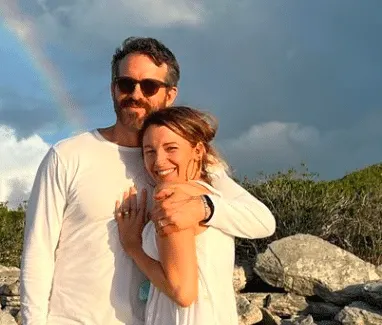 Ryan Reynolds celebrates Blake Lively on her birthday with a photo of them together at the beach, standing in front of a rain