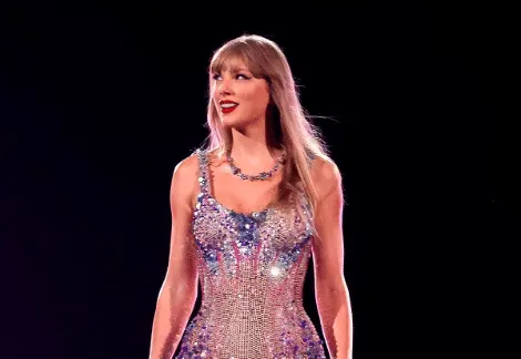 Taylor Swift performs on stage at her Eras Tour. Today she has announced the concert film!