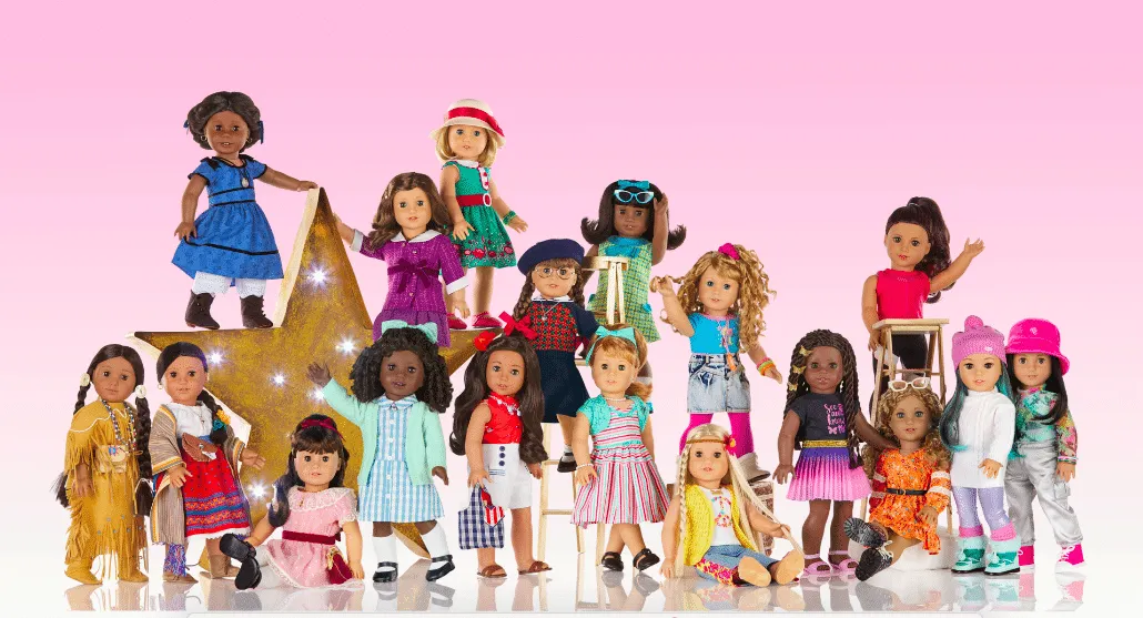 A photo of American Girl dolls placed beside each other. They are of different backgrounds and ethnicities.