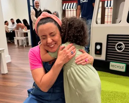 Ms Rachel hugging Rahaf from Gaza after meeting the young girl through the Palestine Children's Relief Fund.