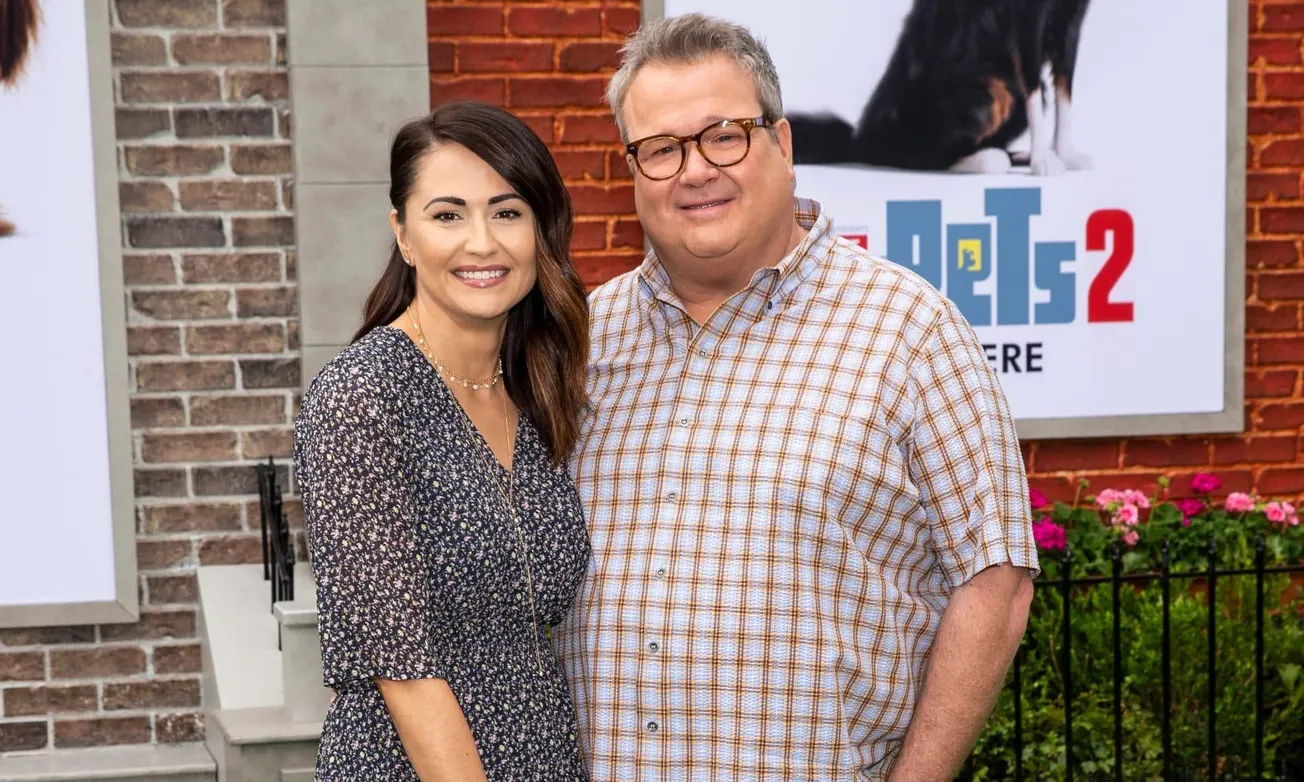 Lindsay Schweitzer and Eric Stonestreet smile at a movie premiere.