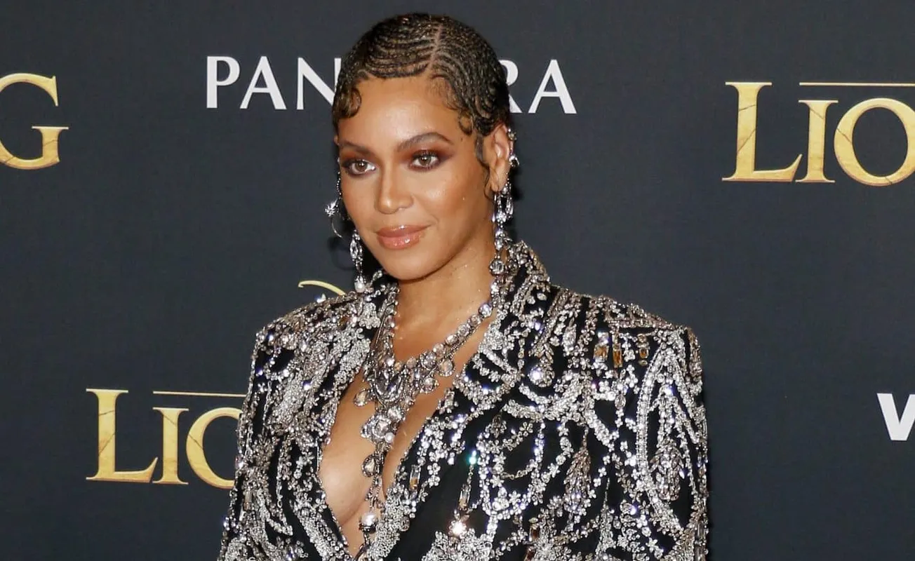 Beyoncé attends a press event for The Lion King dressed in a jewelled jacket.