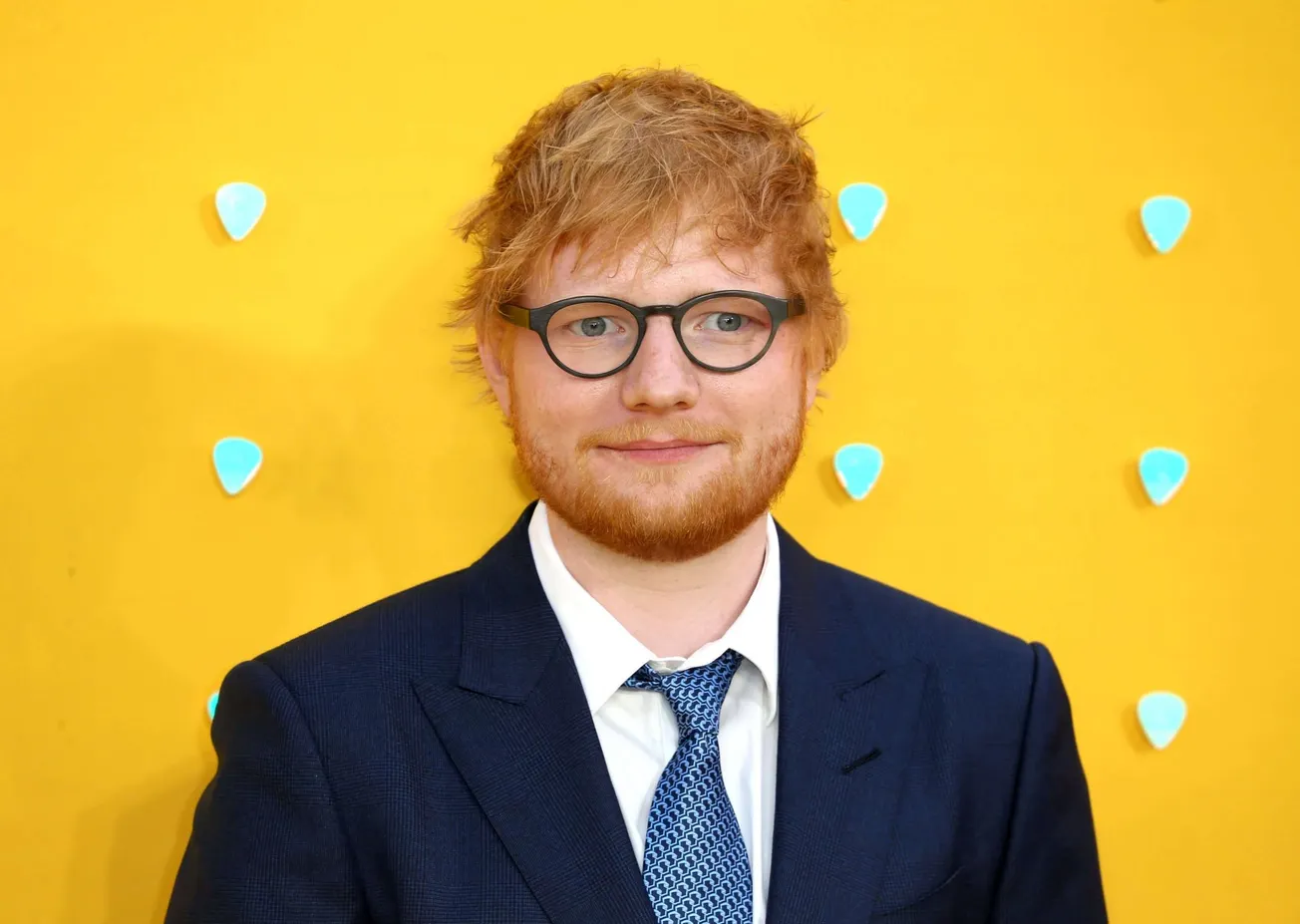 Ed Sheeran smiles at a press event.