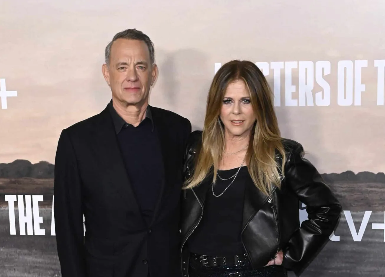 Tom Hanks and Rita Wilson together at a press event. They're both dressed in black