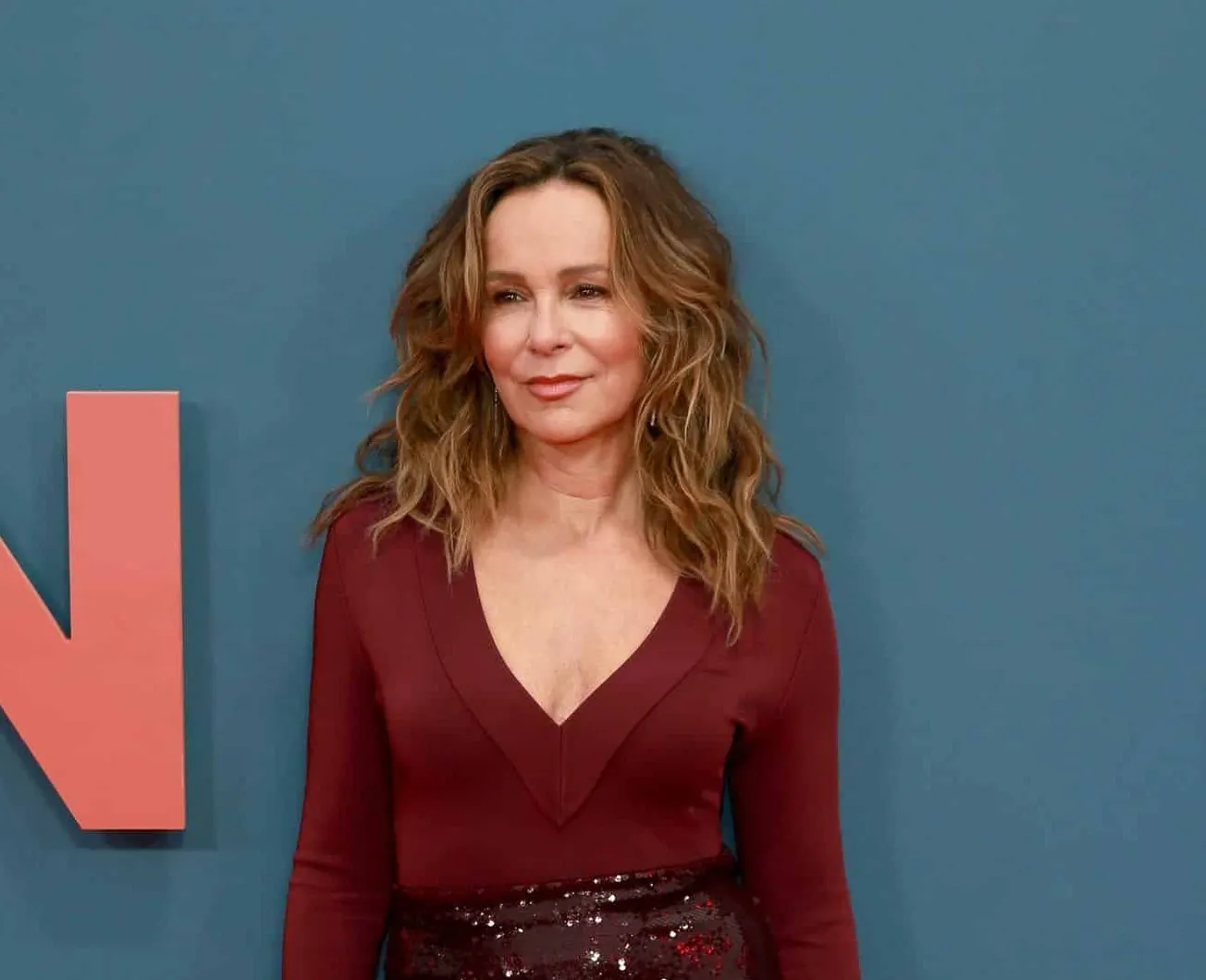 Jennifer Grey smiles at a press event.