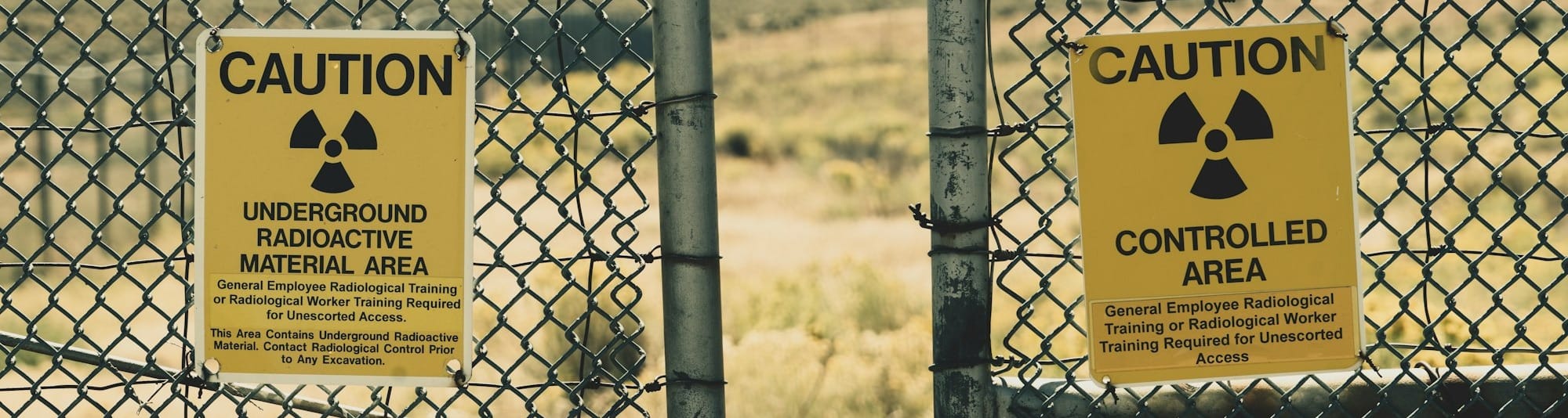 a couple of signs that are on a fence