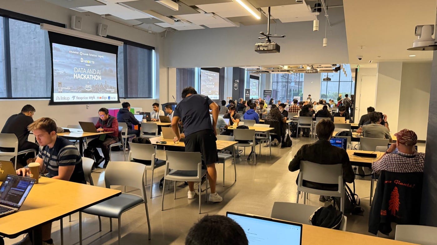 The Data & AI Hackathon under way at the AWS Builder Loft in San Francisco, builders at laptops with the event slide on the screen