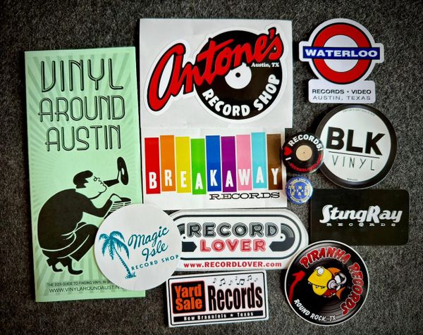 Stickers, pins, and a brochure from record stores across Austin and some of the surrounding towns.