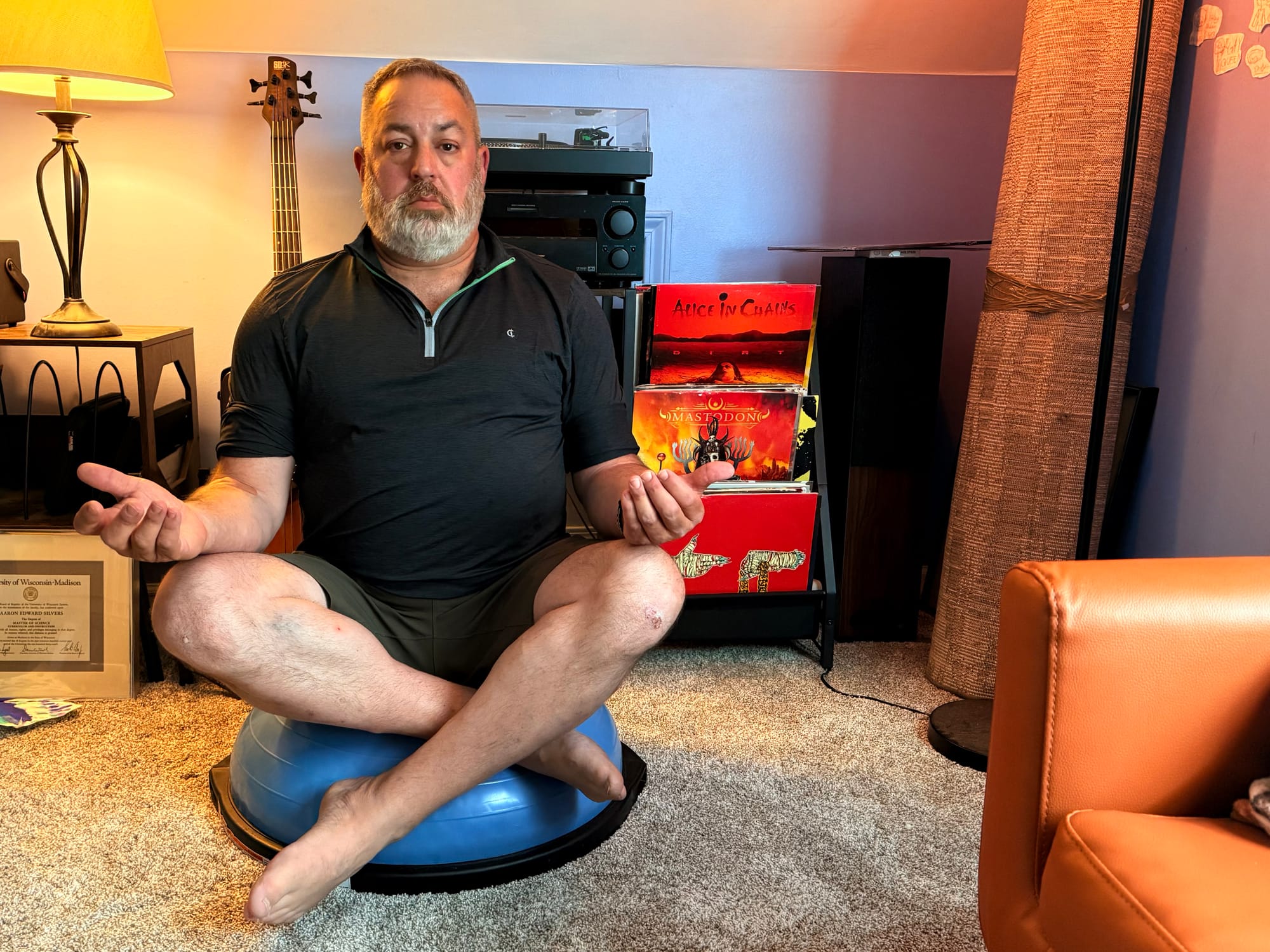 I am sitting cross-legged on a BOSU trainer in front of my newly connected stereo and vinyl collection.