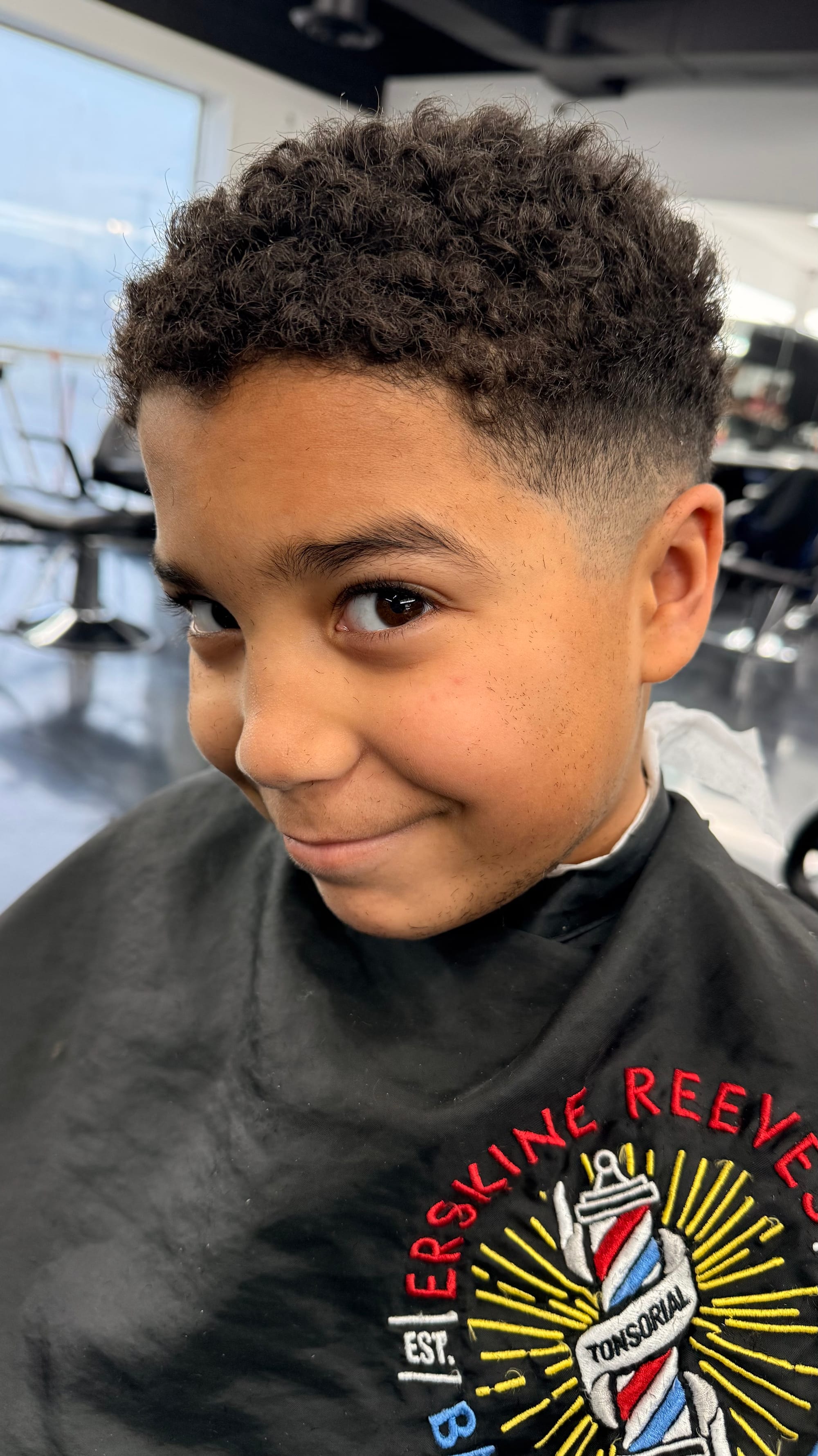 a young boy with a fresh low drop fade