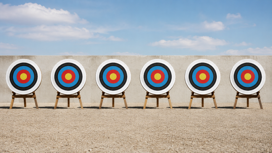 Six separate archery targets standing next to each other.
