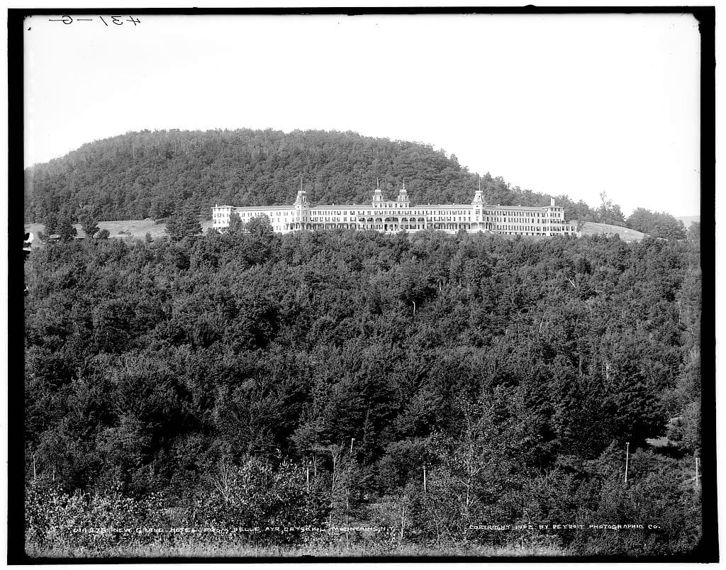 [b+w photograph of a grand old hotel high in the mountains]