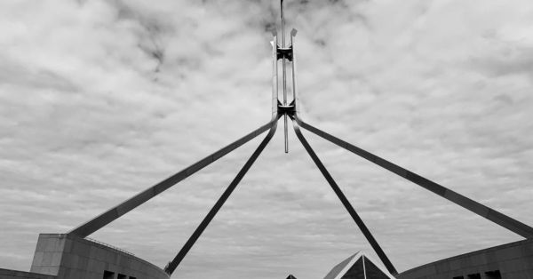 Photo of New Parliament House, representing Australian politics. The photo is of the four beams coming to the roof of the bui