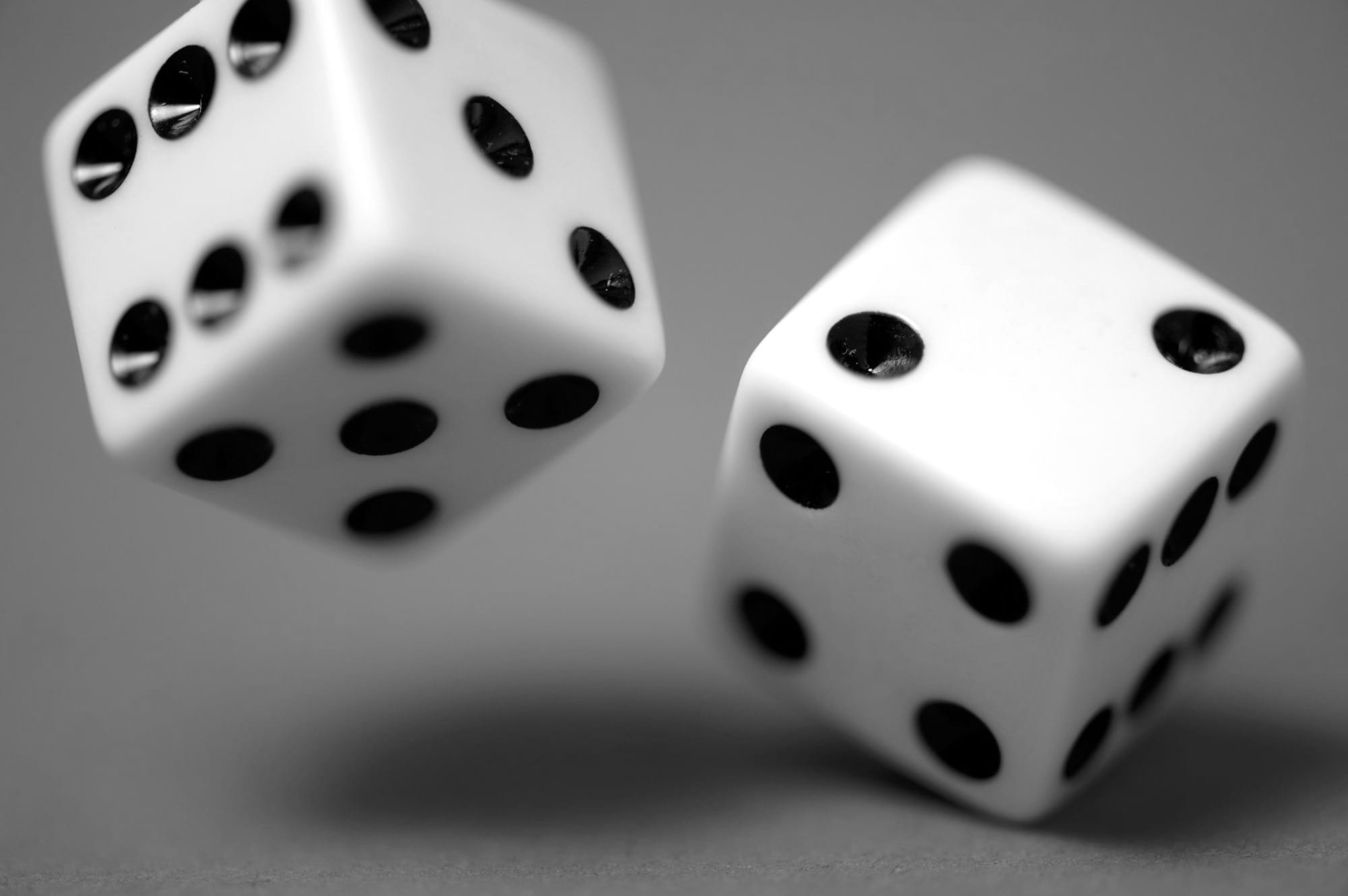 2 white dices on blue surface