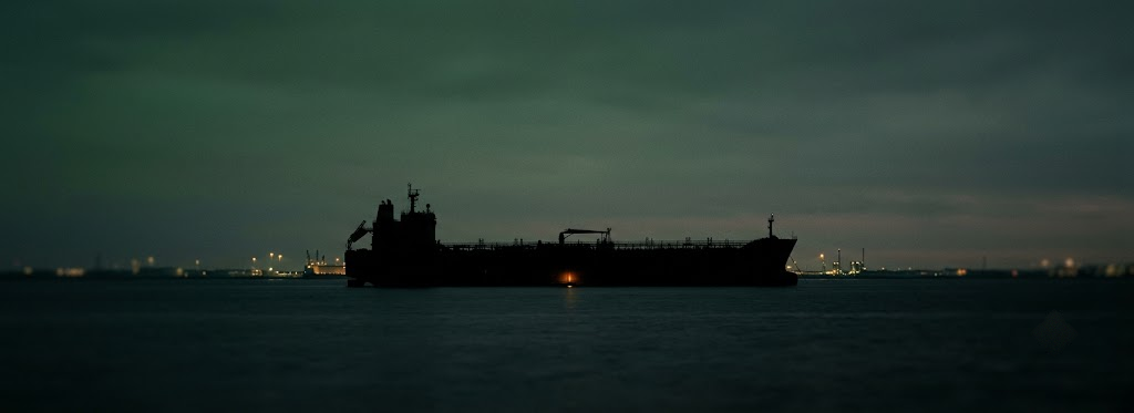 Oil tanker silhouetted at dusk