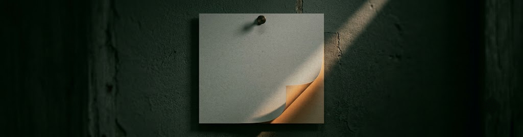 A wall calendar page curling at its lower corner