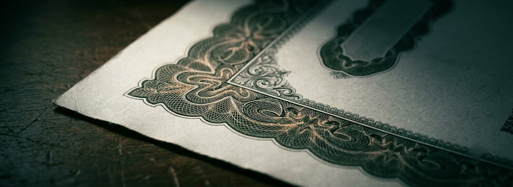 An engraved paper bond certificate in raking light