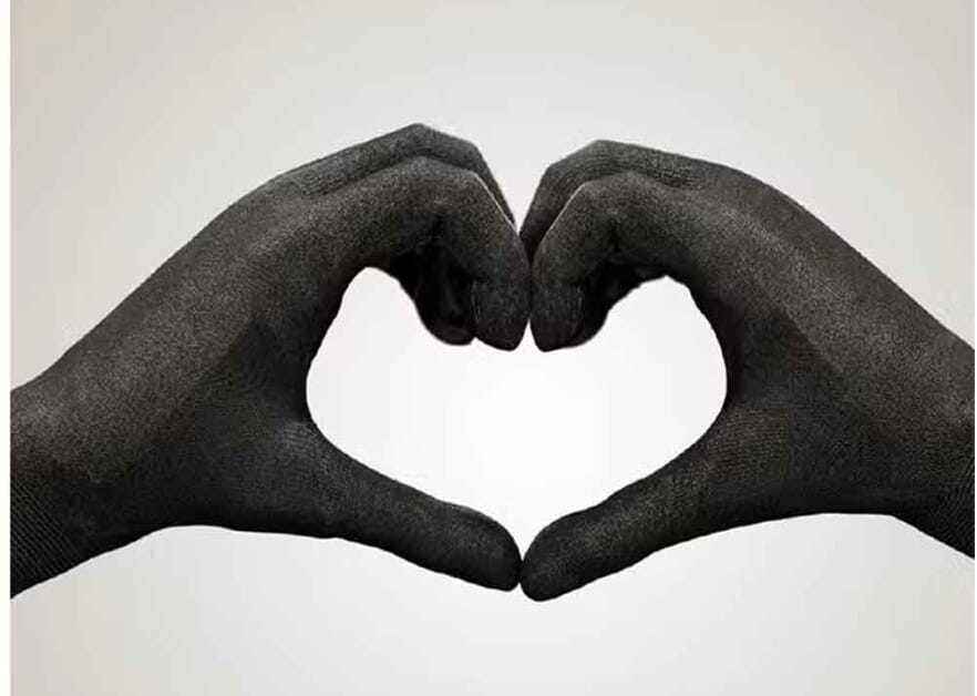 Two gloved hands forming a heart shape