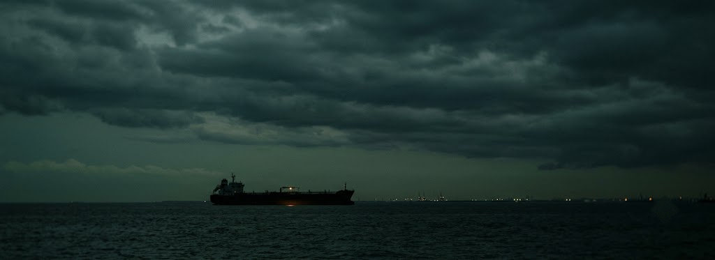 Oil tanker at dusk on dark water