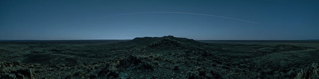 A bare high-desert ridge at blue hour with no cell tower in sight