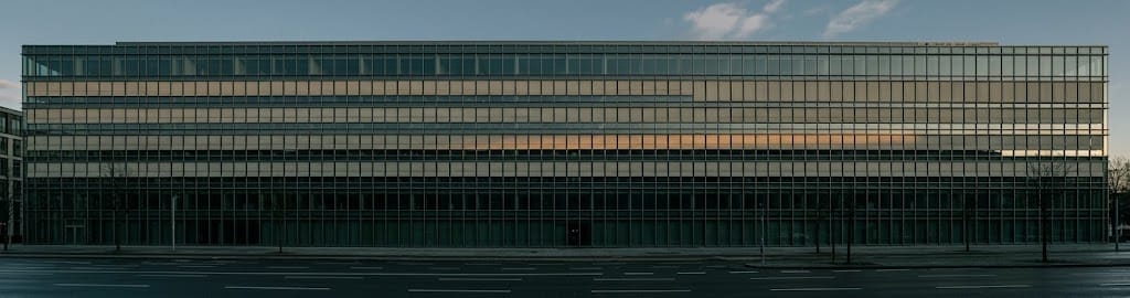 A glass office facade in low sun