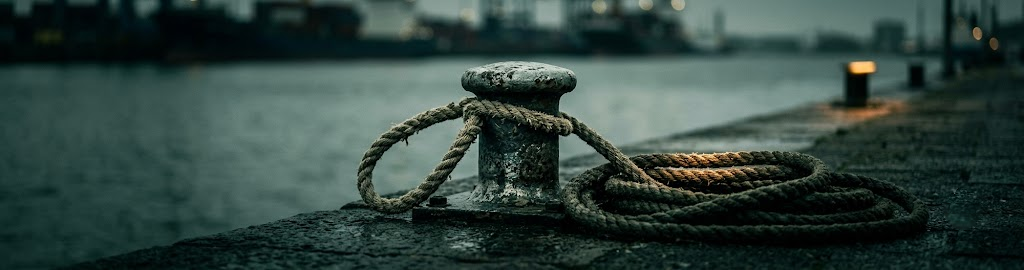 A heavy mooring rope looped over a bollard