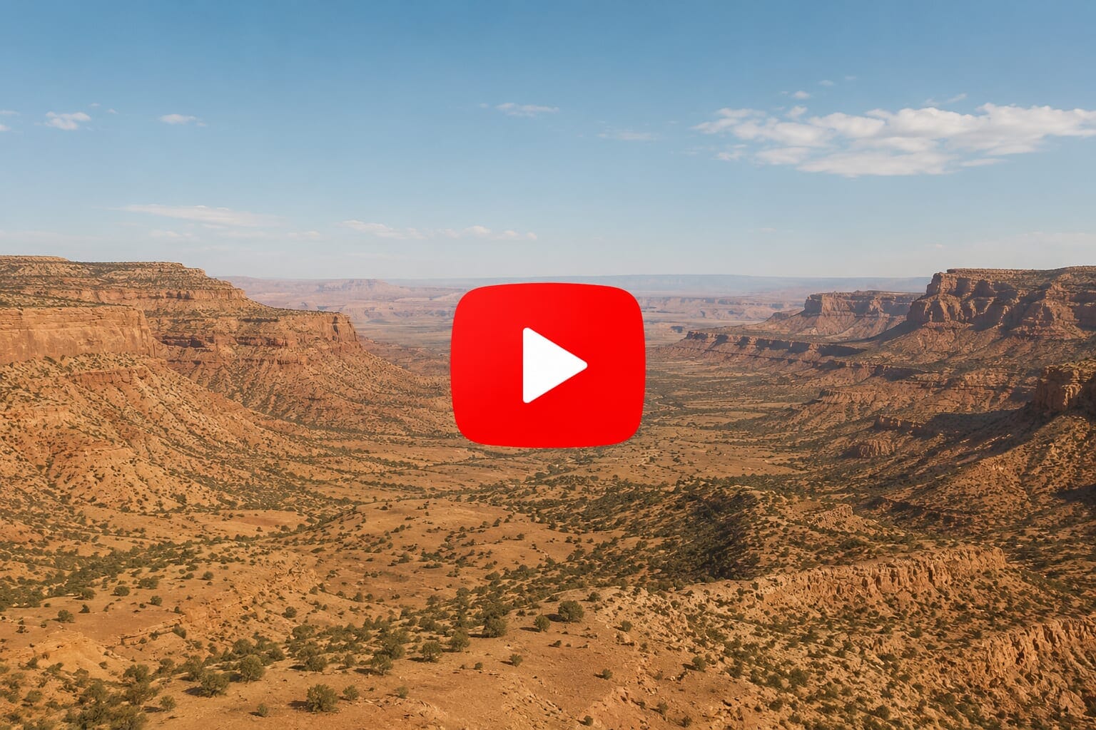 Desert canyon landscape with YouTube play button