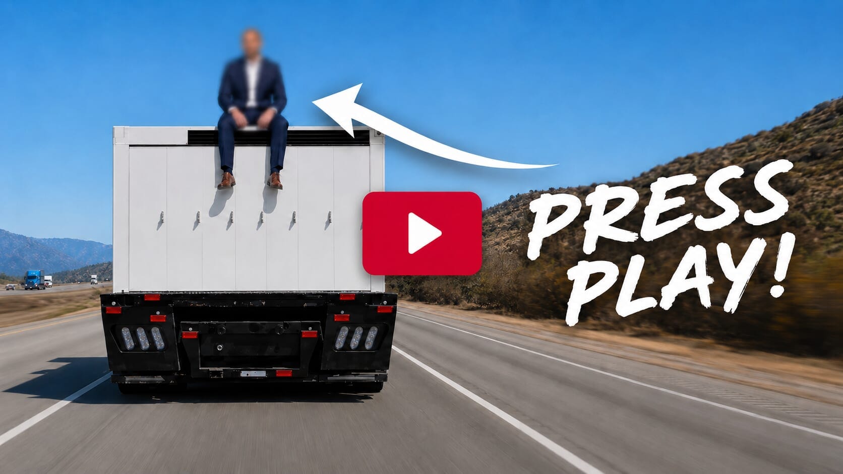 Man sitting on top of a moving truck