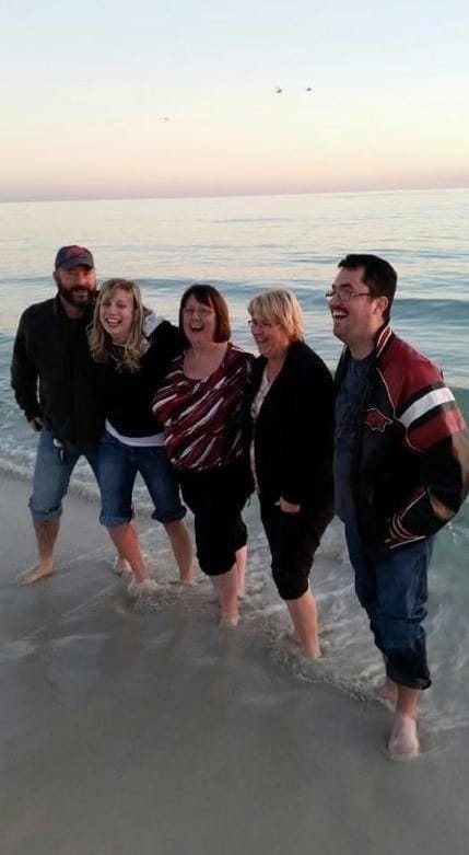 A group of people standing on a beach

AI-generated content may be incorrect.