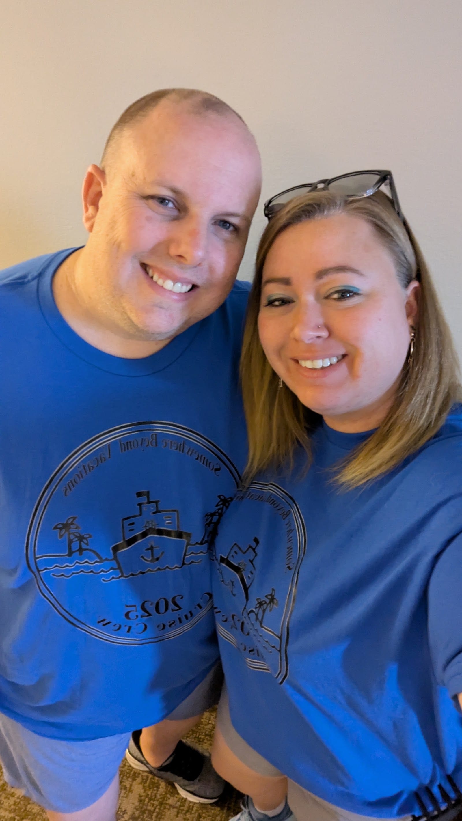 Cody Thomas with a Somewhere Beyond Vacations advisor in matching blue SBV Cruise Crew shirts