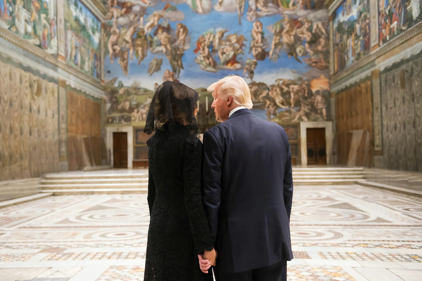 Donald and Melania Trump holding hands in the Sistine Chapel.