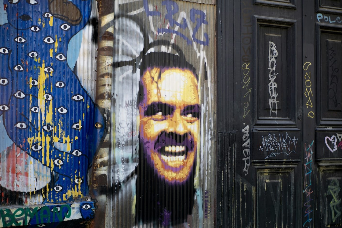 Graffiti mural of Jack Nicholson’s famous “Here’s Johnny” scene from The Shining, used humorously to illustrate the painful but necessary process of editing.