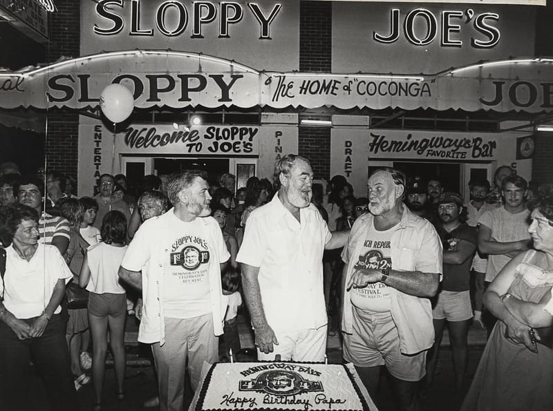 Bill Young, pictured centre, winner of 4th Hemingway lookalike contest standing outside Sloppy Joe's bar.