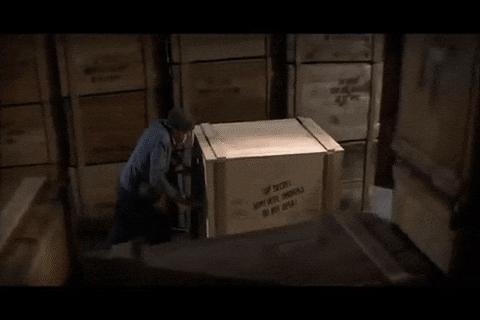 Animated GIF of the vast warehouse scene from Indiana Jones, with endless crates stacked high.