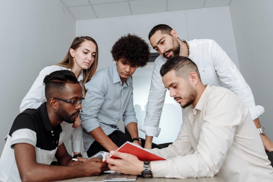 Five stock models looking at a notepad