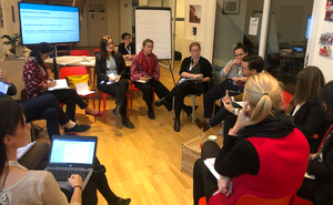 A group of communications experts sitting in a circle