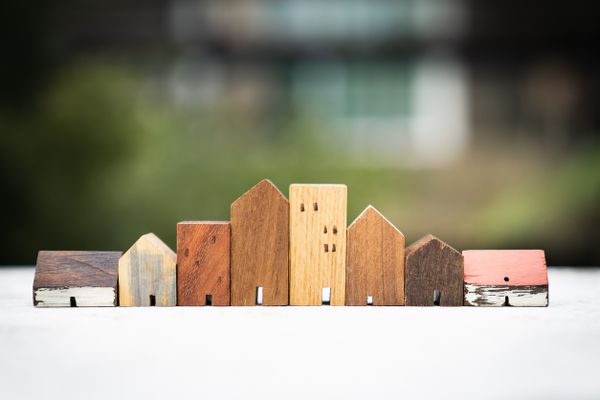 House model on wood table. Real estate agent offer house, property insurance and security, affordable housing concepts
