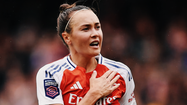 Caitlin Ford of Arsenal Women in a home game at Meadow Park tapping the Arsenal logo on her shirt