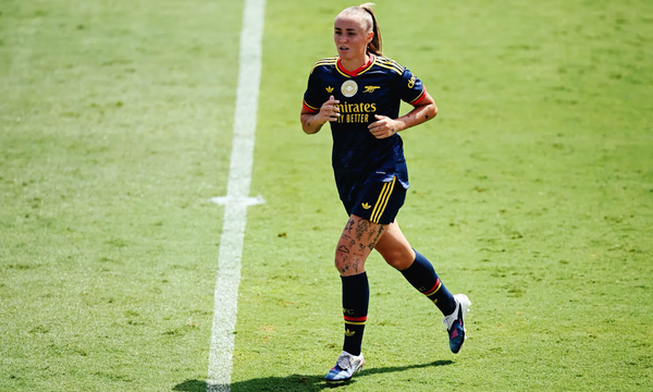 Georgia Stanway of Arsenal Women runs across the pitch during a game in Arsenal's deep blue away kit.