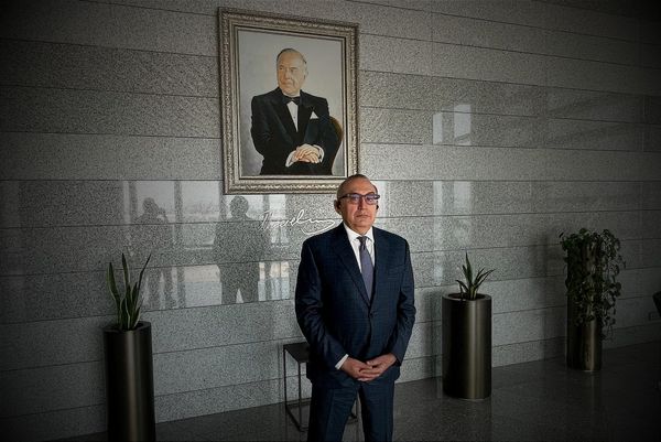 SOCAR deputy Vice President Vitaliy Baylarbayov stood in front of a portrait photo of Azerbaijan's ex- president Heydar Aliyev, in June 2025. Photo © Seb Kennedy / Energy Flux