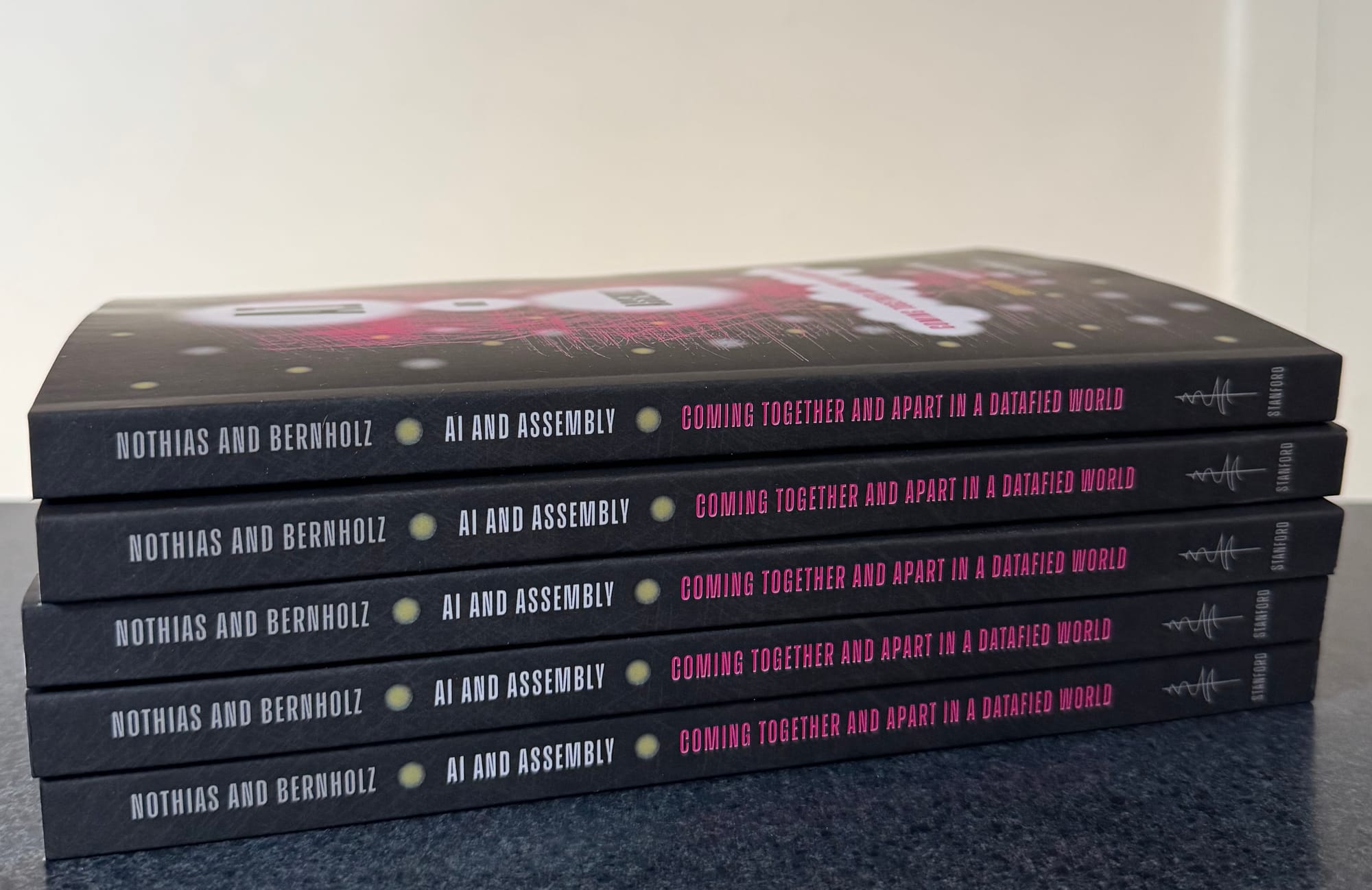 Stack of five copies of AI and Assembly showing spines