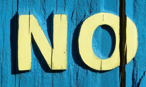 Blue background with yellow word NO 