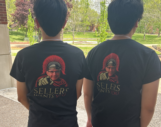 Two students wearing matching black T-shirts. 