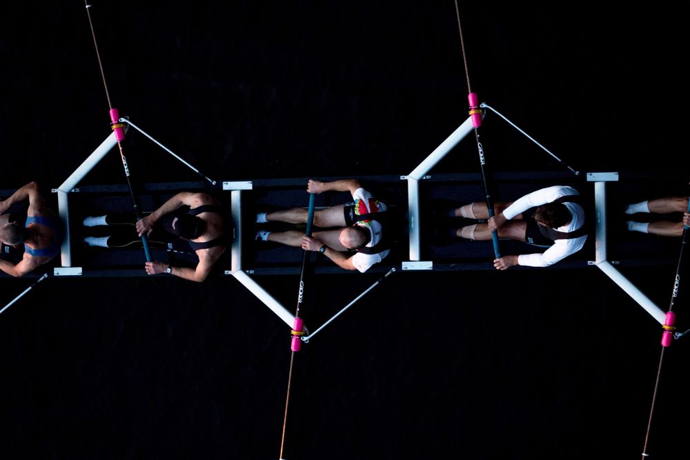 a group of people rowing 