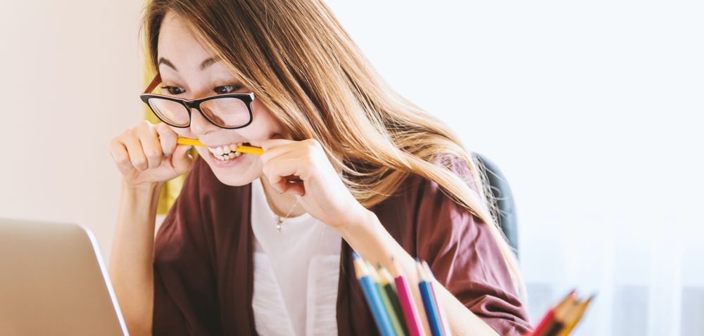 woman biting a pencil