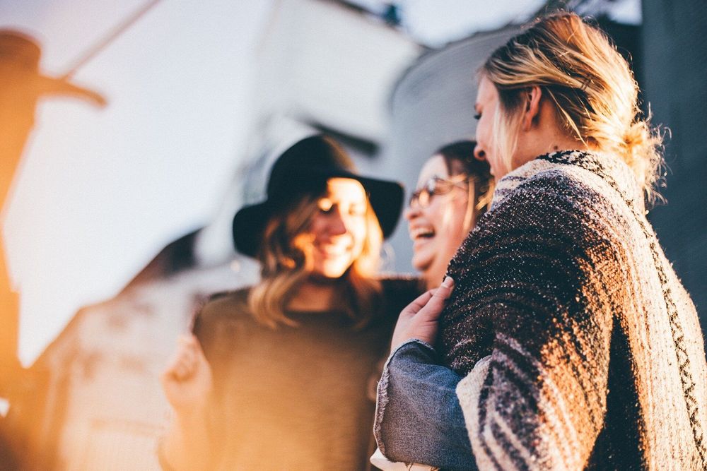 three female friends laughing