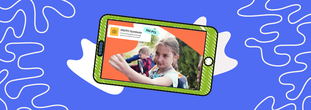 An elementary school student taking part in a Goosechase Experience inspecting a leaf on a field trip