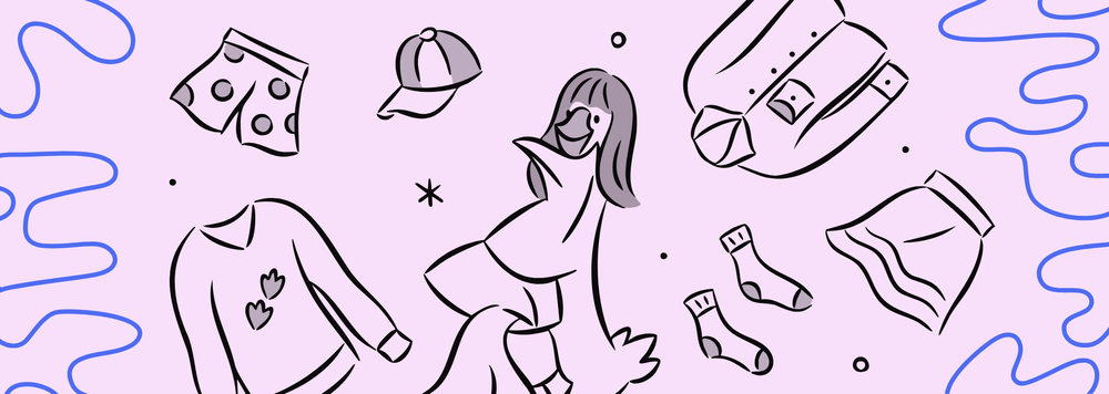 A goose surrounded by items of clothing like hats, socks, and sweaters.