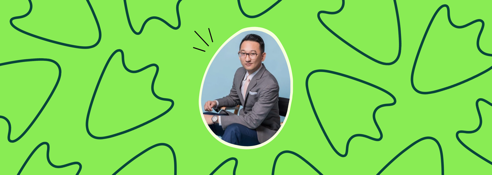 One smiling man in egg-shaped frame on a green background with black goose footprints.