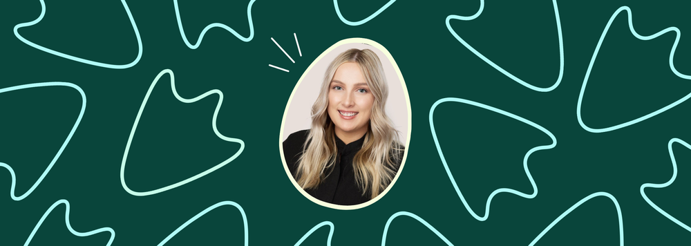 A headshot of a smiling woman with blonde hair